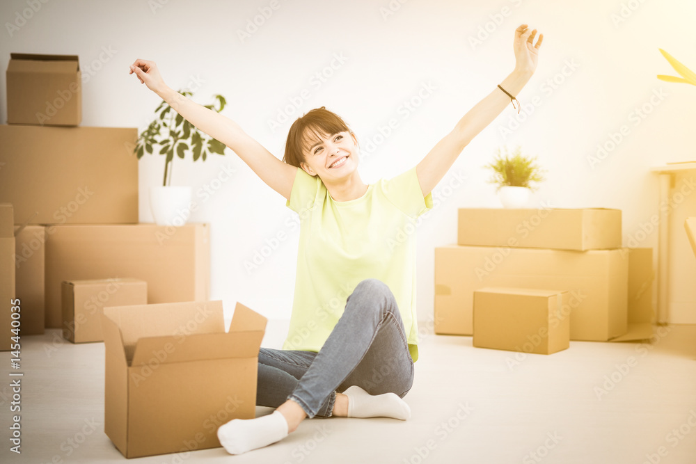 Young happy woman, a student, moved into a new apartment. Young happy woman, a student, moved into a new apartment.