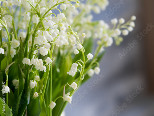 Lilies in a white wicker basket. Fresh spring flowers as a gift. Free space on the right for text or design