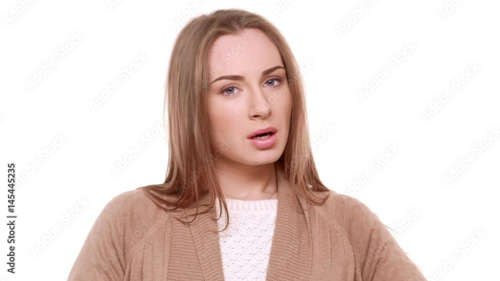 Angry Caucasian beautiful young female arguing with boyfriend standing on white background in despair in slowmotion Angry Caucasian beautiful young female arguing with boyfriend standing on white background in despair in slowmotion