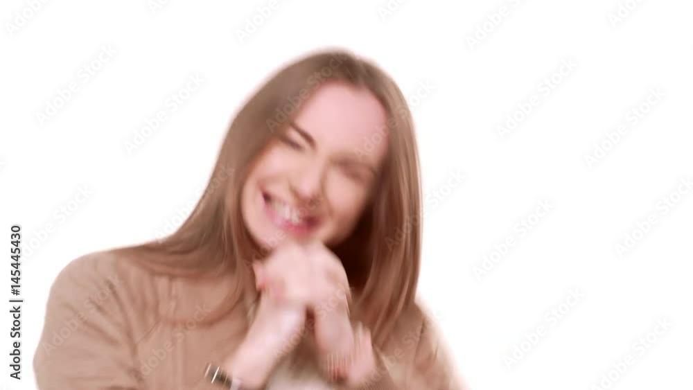 Young attractive Caucasian female with light brown hair rejoicing from unexpected prize smiling jumping on white background Young attractive Caucasian female with light brown hair rejoicing from unexpected prize smiling jumping on white background
