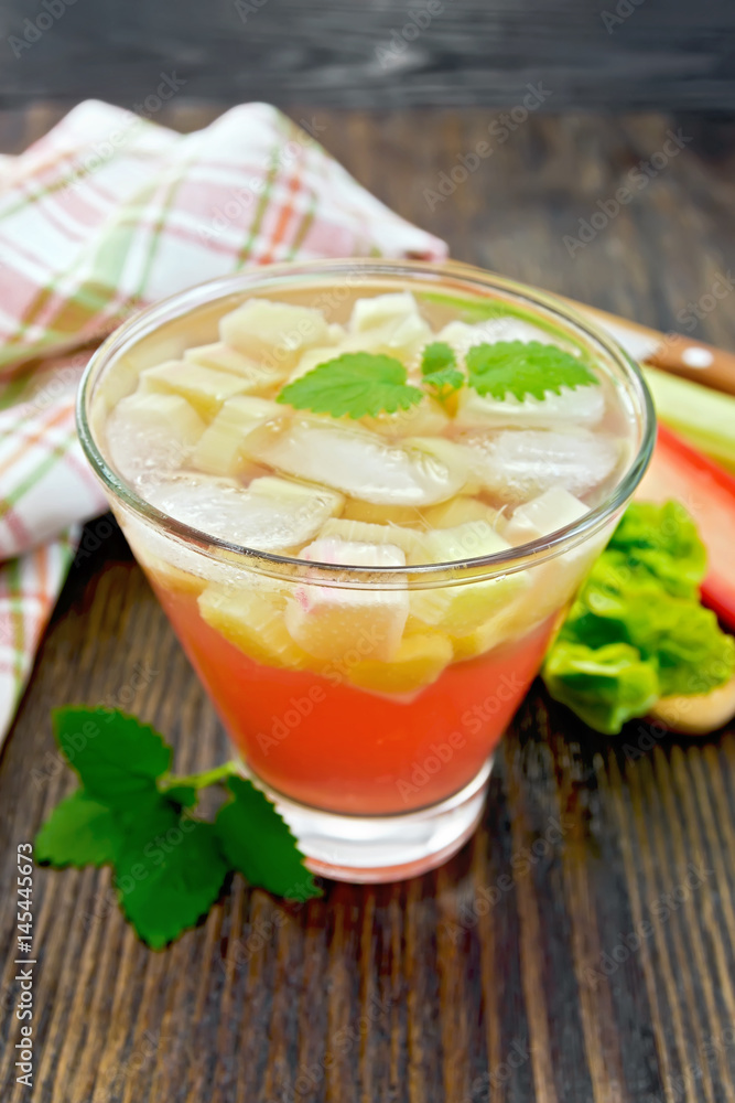 Lemonade with rhubarb and mint on wooden table