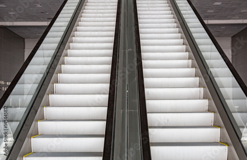 Futuristic metal escalator for lifting people in a modern shopping mall
