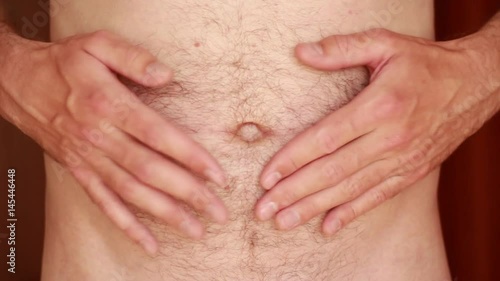 Man patting on belly closeup