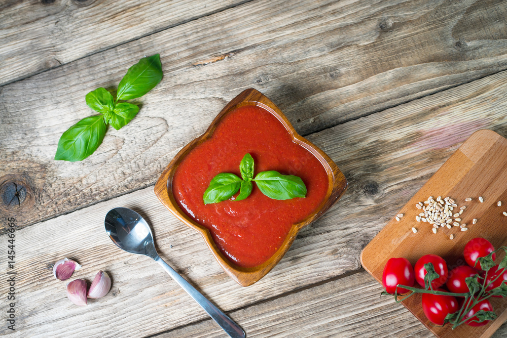 Tomato soup on wooden table, top view, place for typography Tomato soup on wooden table, top view, place for typography