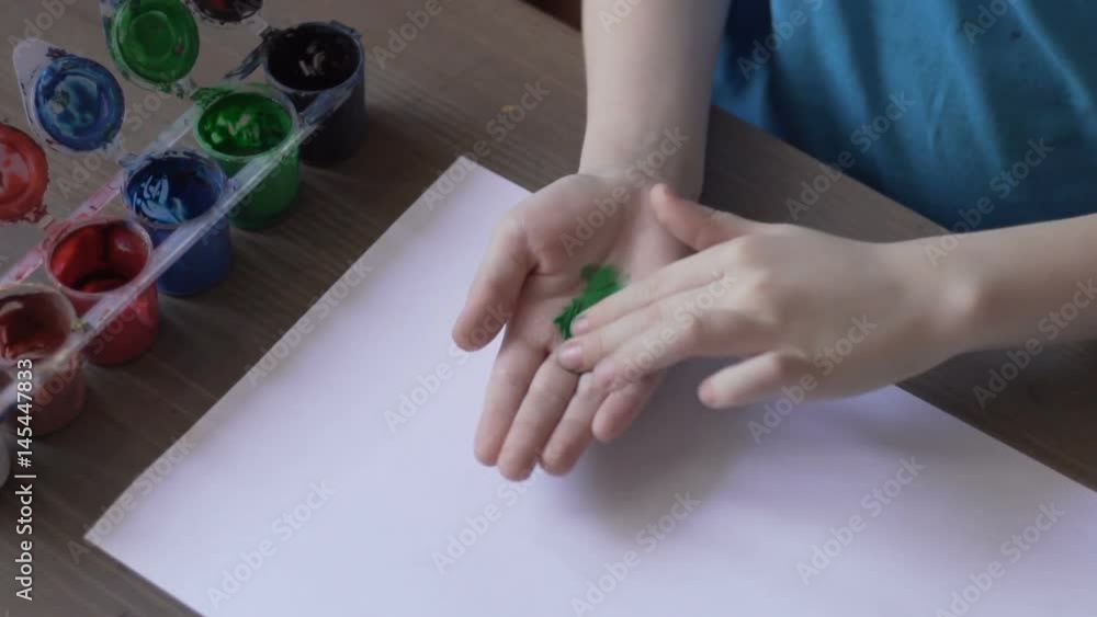 The child paints. Paint for drawing with fingers. The child paints. Paint for drawing with fingers.