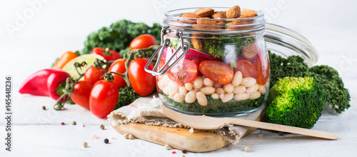 Healthy vegan salad in a mason jar with beans