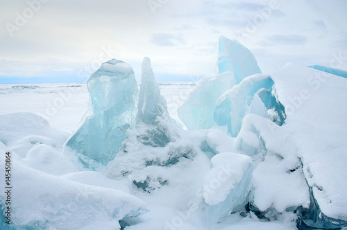 Сибирь, озеро Байкал, ледяные торосы в пасмурный весенний день   © irinabal18