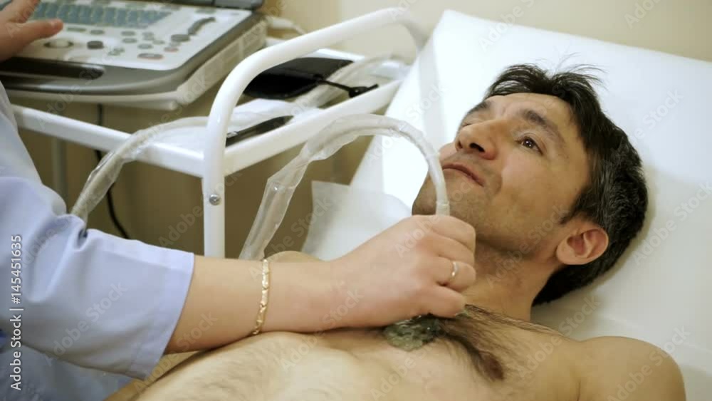 Echocardiography. Female doctor examining a patient's heart by using an ultrasound equipment. HD Echocardiography. Female doctor examining a patient's heart by using an ultrasound equipment. HD