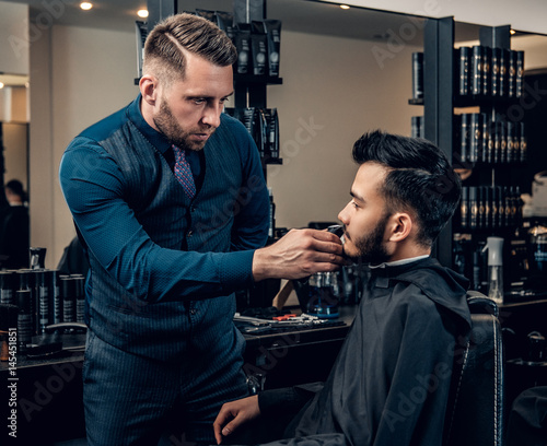 Men's beard grooming with the electronic beard trimmer.