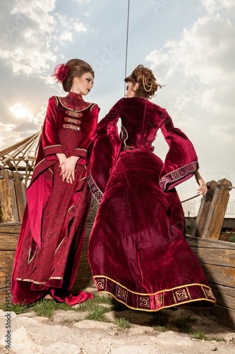 Two ladies in luxury vintage clothes on a boat. Luxury and glamour