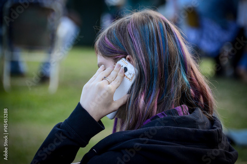 Young woman talking on mobile phone at festival