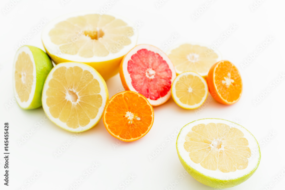 Tropical mix with fresh lemon, orange, mandarin, grapefruit and sweetie on white background. Flat lay, top view.