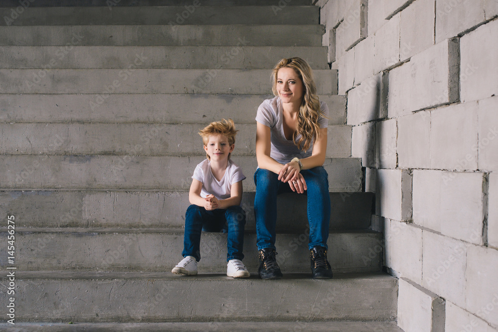 Mother with son sitting on a stairs