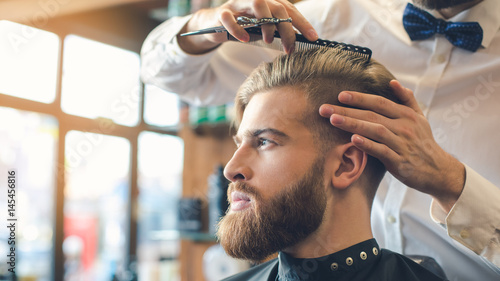 Photographie Young Man in Barbershop Hair Care Service Concept
