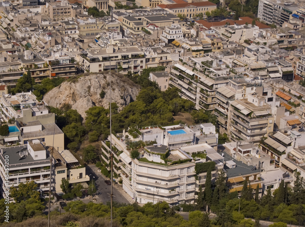 Panorama of the city of Athens in Greece. The unusual landscape. The mountain in the middle of the courtyards.