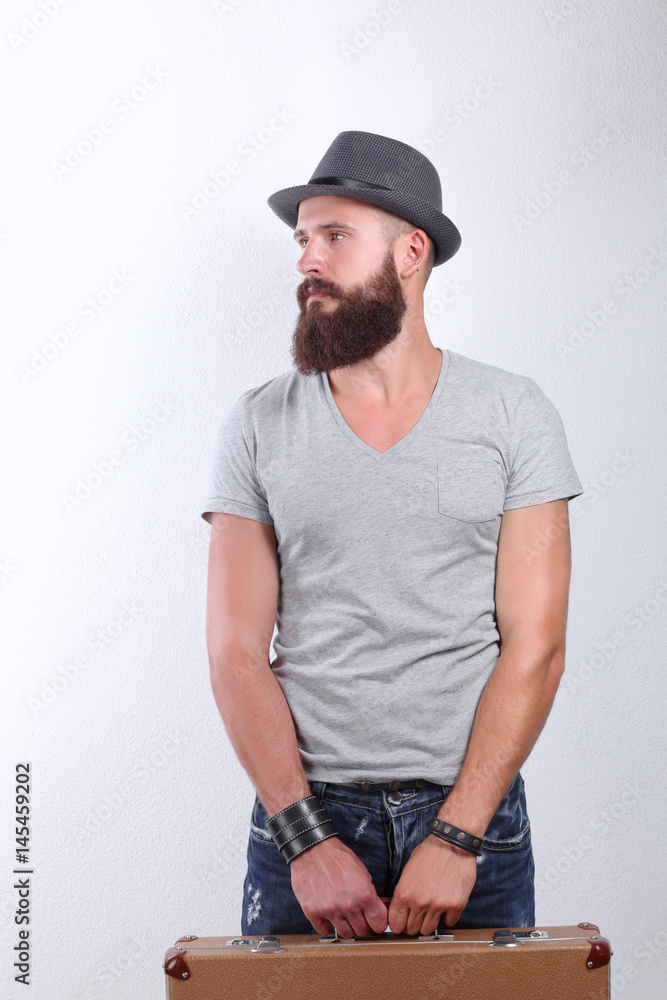 Portrait of handsome bearded man in hat standing with bag, isolated on white background Portrait of handsome bearded man in hat standing with bag, isolated on white background