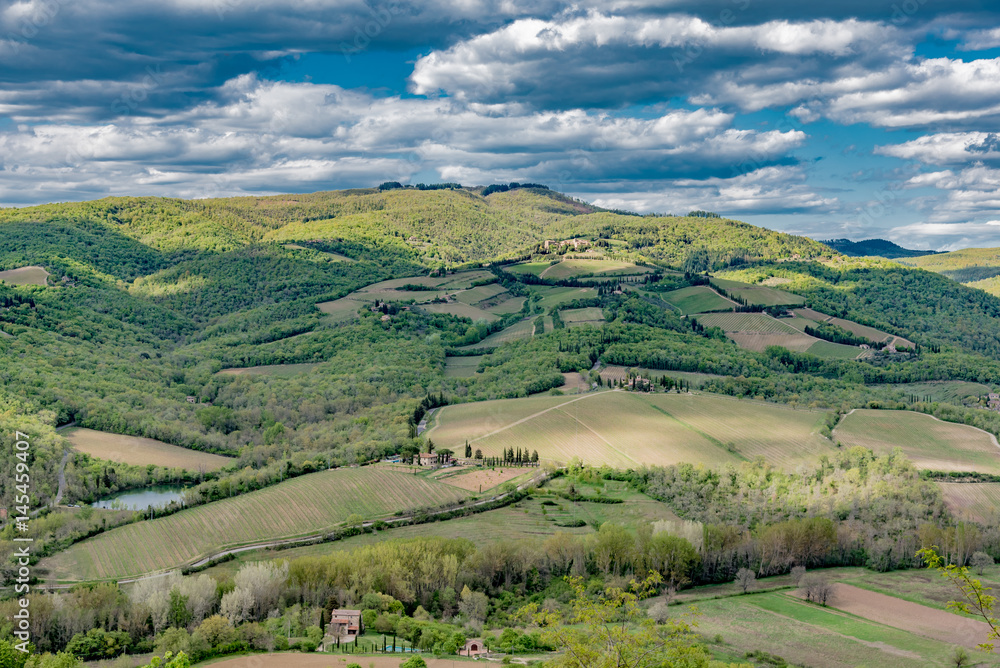 the Chianti countryside in Tuscany with vineyards and villas and farmhouses in the hills