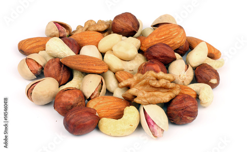 mix almonds, cashew nuts, hazelnut, peanuts, walnuts, pistachio in wood plate isolated on white background