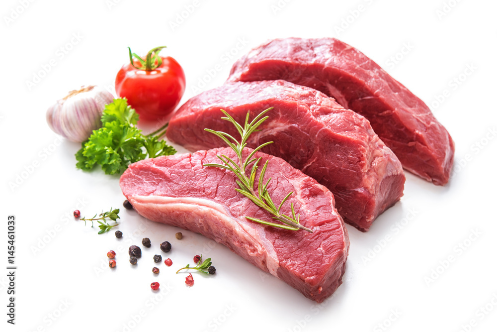 Pieces of raw roast beef meat with ingredients