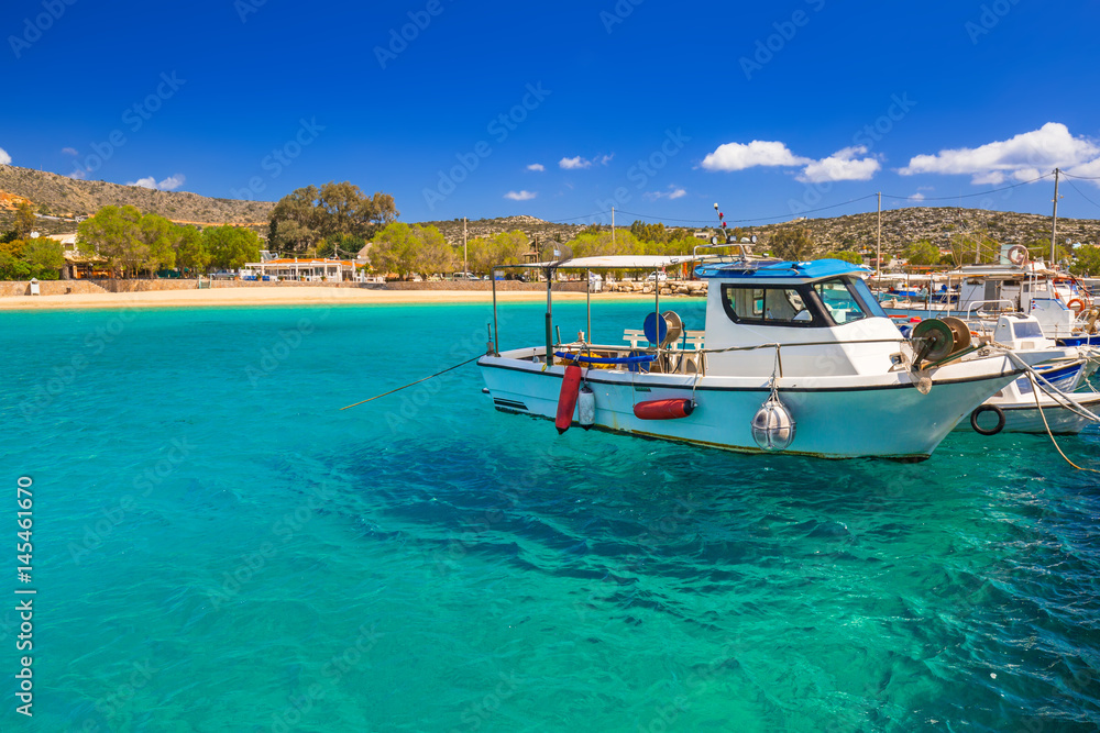 Blue lagoon of Marathi bay with fishing boats on Crete, Greece