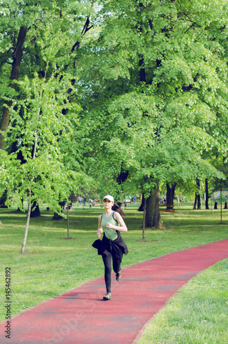 moment, girl running in the distance at which the professional track runner