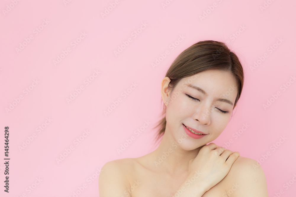 Asian beautiful woman touching on her shoulder perfect skin with copy space,isolated on pink background Asian beautiful woman touching on her shoulder perfect skin with copy space,isolated on pink background