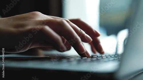 A  business woman's hands working and typing on laptop keyboard 