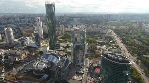 Downtown Yekaterinburg best Russian aerial cinematic flight. Important sightseeing Modern skyscrapers skyline hotel Eltsin center. River embankment. Beautiful sunny day. High altitude drone 4k drift  photo