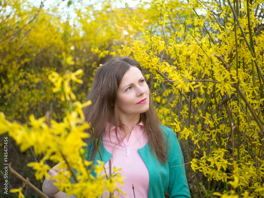 outdoor portrait beautiful girl in green jacket among yellow blossom tree outdoor portrait beautiful girl in green jacket among yellow blossom tree
