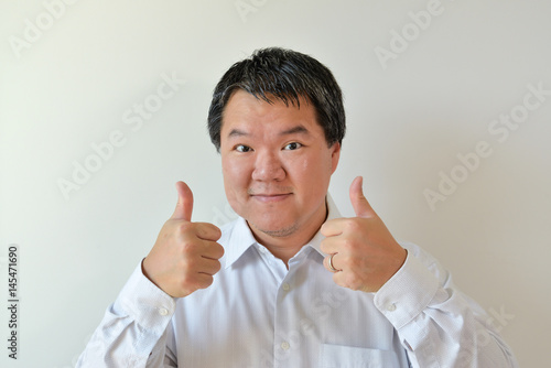 Two thumbs up expression - male adult