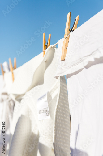 White clothes hung out to dry in the bright warm sun