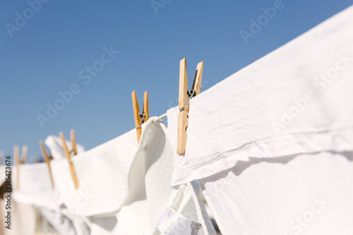 White clothes hung out to dry in the bright warm sun