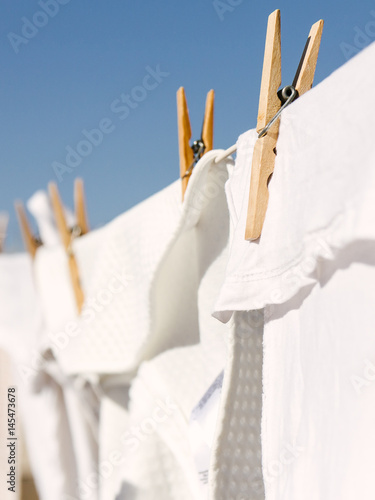 White clothes hung out to dry in the bright warm sun