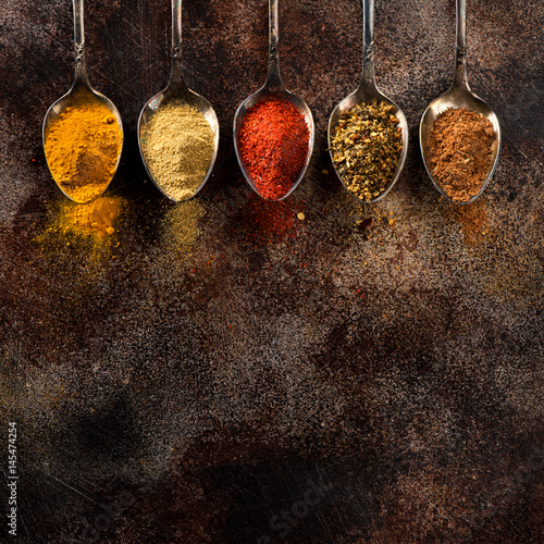 Powder Spices and herbs in old spoons