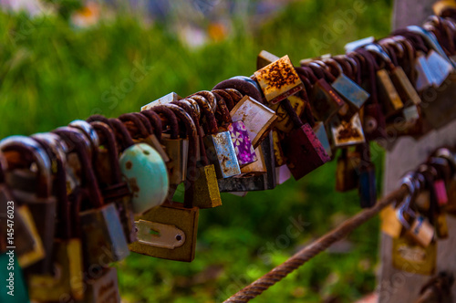 Love padlocks locked on iron chain