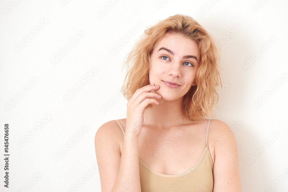 Fototapeta premium Portrait of a girl blonde on white background