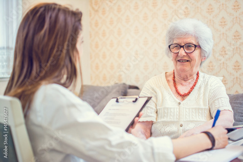 Senior woman is visited by her healthcare worker at home.
