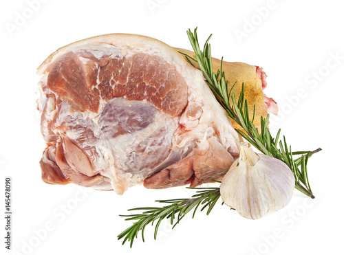 Raw pork knuckle with rosemary and garlic on a white background
