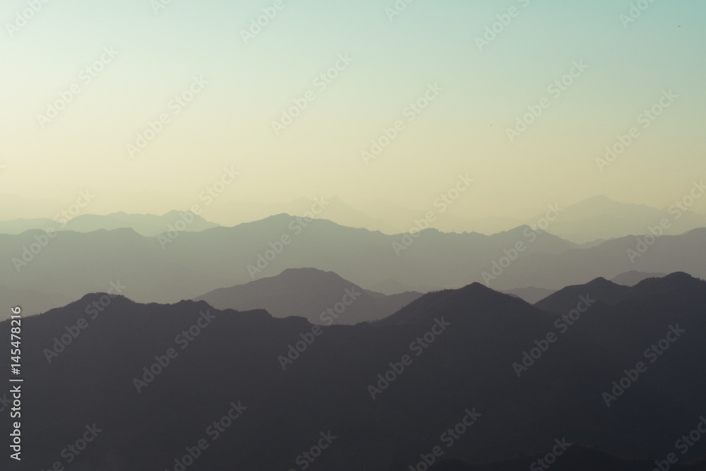 Landscape of nature mountain terrain hills layered in silhouette shade - with copy space