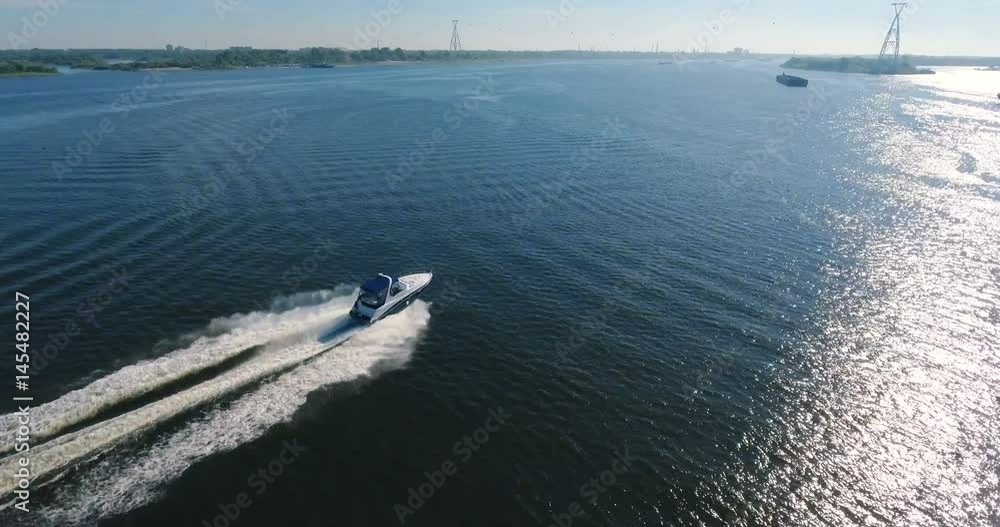 A motorboat is sailing on the pond