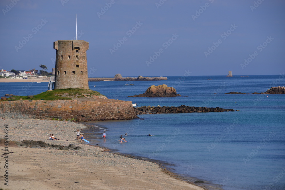 Le Hocq, Jersey, U.K.   Telephoto coastal image of the 19th century Napoleonic harbour and architecture on a present Spring day at high tide.