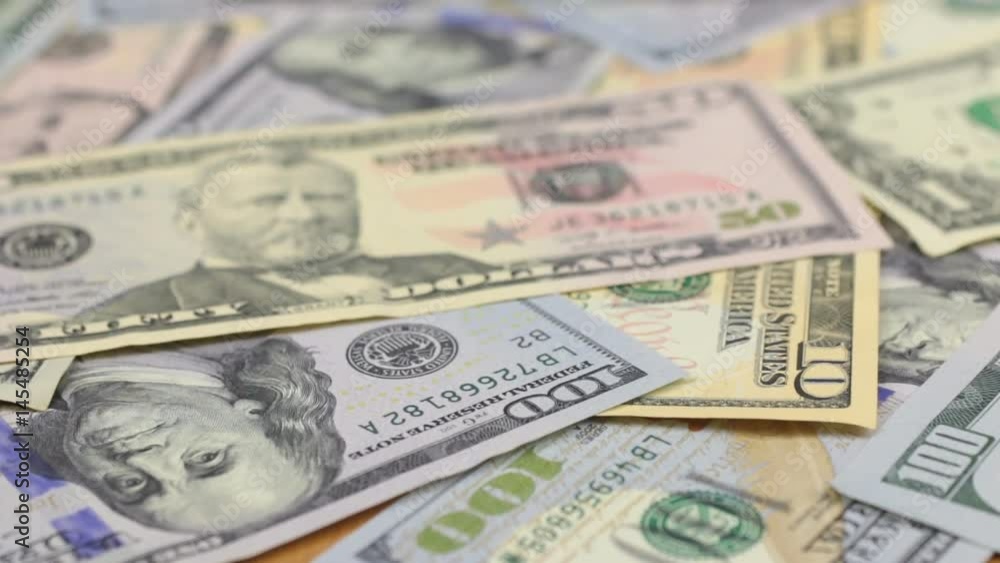 Close-up of gold glasses lying on dollars. Close-up of gold glasses lying on dollars.