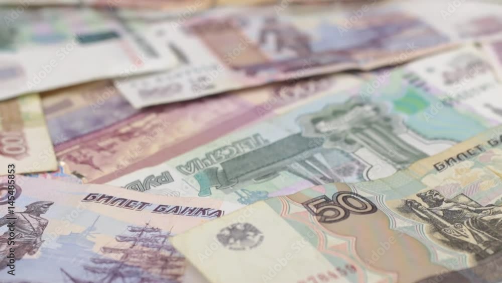 Close-up of gold glasses lying on rubles. Close-up of gold glasses lying on rubles.