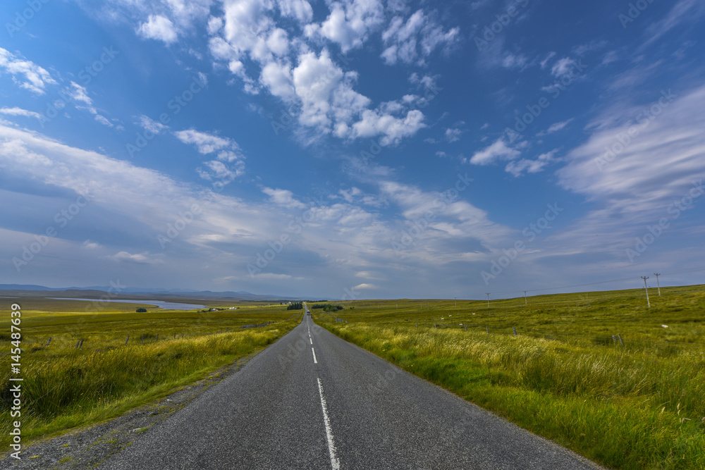 Asphalt road panorama in scottish countryside on sunny sommer day, Harris and Lewis island, Scotland, Great Britain