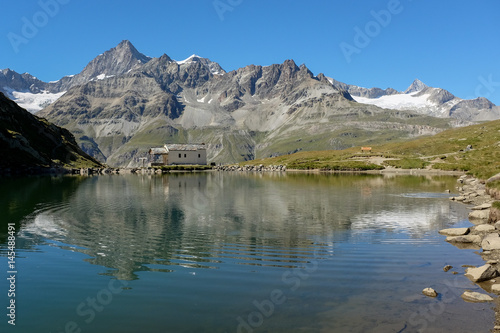 Swiss mountains reflected in lake Schwarzsee, near Zermatt, Switzerland.