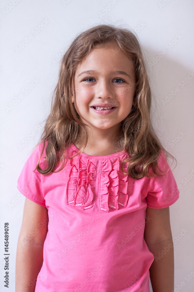 Little Russian Six-Year Girl In Pink T-Shirt On White Background. Little Russian Six-Year Girl In Pink T-Shirt On White Background.