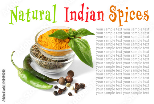 Assortment of spices in glass bowls on white background