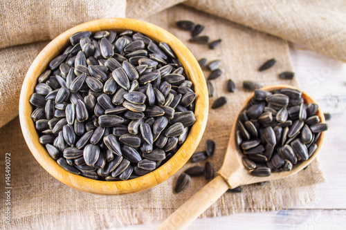 Fresh Sunflower seed. Shelled sunflower seeds in wood bowl.