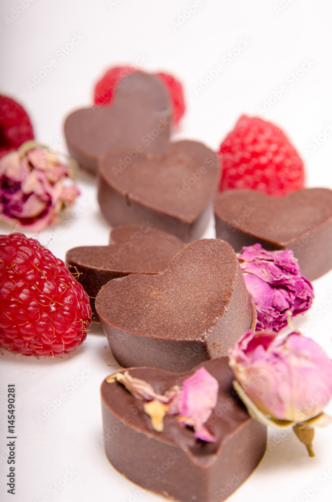 Raw chocolate hearts and raspberries Raw chocolate hearts and raspberries