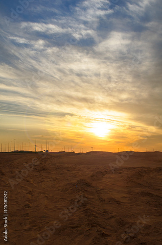 Sunset in the beautiful sand dunes of Dubai
